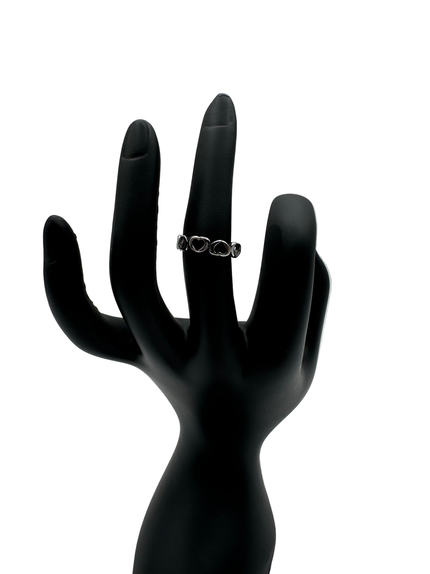Silhouette of a hand holding a ring against a gray background